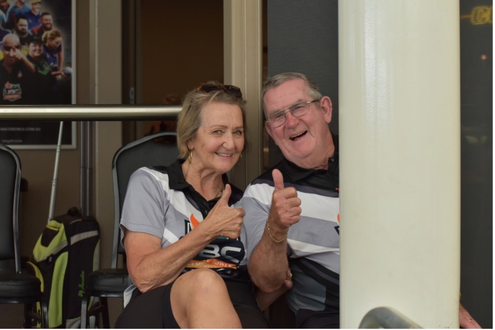 Two UBC volunteers smiling and giving a thumbs up