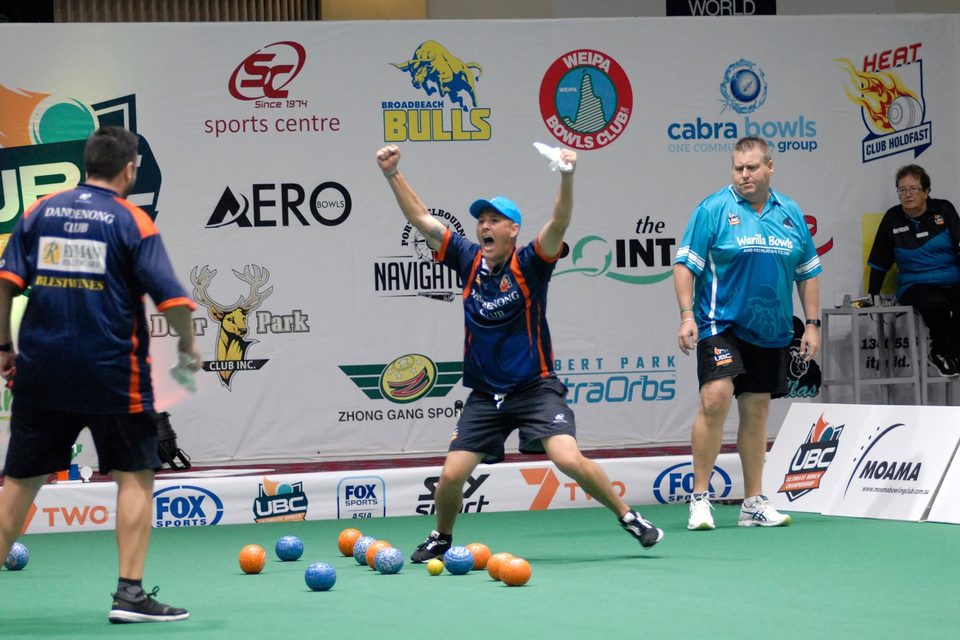 Dandenong Club player throwing his arms up in celebration on the rink