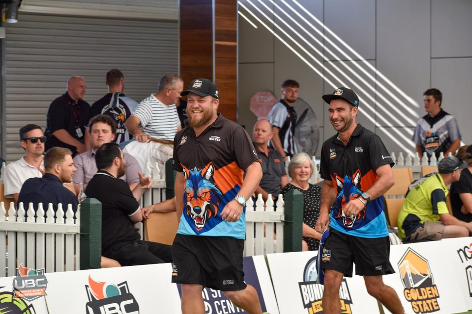 Two Western Wolves players laughing as they walk out past the crowd