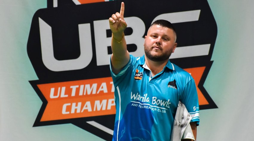 Warilla Gorillas player pointing skyward in front of the Ultimate Bowls™ Championship banner during Ultimate Week 2023